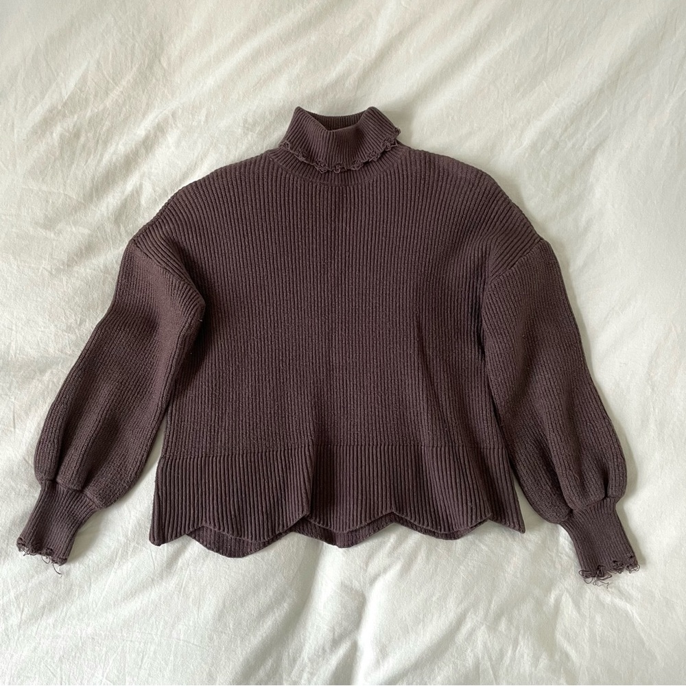 brown turtleneck sweater with distressing on sleeves and neck